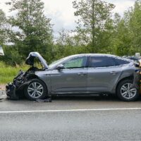 damaged cars on the highway at the scene of an accident